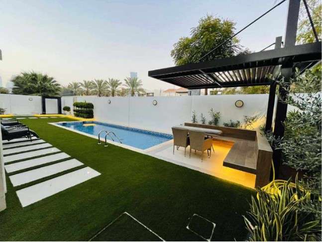 Explore the allure of a beautifully landscaped backyard in Dubai, featuring a sparkling swimming pool and stylish outdoor furniture. This oasis reflects the exceptional craftsmanship of landscaping companies in Dubai, creating a harmonious blend of aesthetics and functionality in your outdoor space