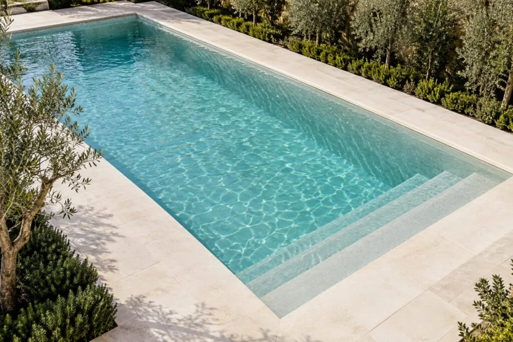 AI design inspiration for a turquoise swimming pool with pale stone surround